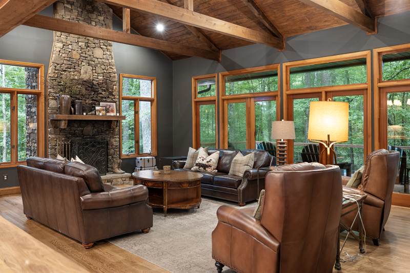 A stacked-stone fireplace running to the ridge beam
