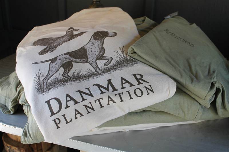 Folded canvas bags printed with a pointing dog and the DanMar Plantation name